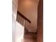 The home's staircase has carpeted steps, leading up to the next level, with a wooden handrail against the wall at 3036 S Semoran Blvd # S, Orlando, FL 32822