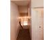 The staircase has carpeted steps, complemented by white walls, and a minimalist wooden handrail for safety and aesthetic appeal at 3036 S Semoran Blvd # S, Orlando, FL 32822