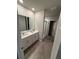 Modern bathroom featuring a double sink vanity, a glass-enclosed shower, and updated fixtures at 3342 Curlew Ave, Leesburg, FL 34748