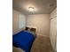 Cozy bedroom features a comfortable bed, window with blinds, carpeted floor, and closet at 3342 Curlew Ave, Leesburg, FL 34748