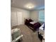 Cozy bedroom featuring carpet flooring, closet storage, and a large window for natural light at 3342 Curlew Ave, Leesburg, FL 34748