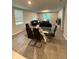 Open-concept dining area featuring a modern glass table, sleek chairs, and a view into the living room at 3342 Curlew Ave, Leesburg, FL 34748