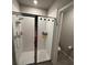 Luxurious walk-in shower with sleek glass doors, modern fixtures, and tiled walls at 3342 Curlew Ave, Leesburg, FL 34748