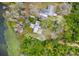 An aerial view showcasing a modern home surrounded by lush trees and tranquil waterfront views at 3807 S Semoran Blvd, Orlando, FL 32822