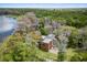 Aerial view of a modern home nestled amongst trees with waterfront views and a serene, private setting at 3807 S Semoran Blvd, Orlando, FL 32822