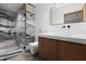 Modern bathroom with walk-in shower featuring designer marble tile, wood vanity, and contemporary fixtures at 3807 S Semoran Blvd, Orlando, FL 32822