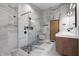 Bright bathroom with a glass enclosed shower, wood cabinets, and marble countertops at 3807 S Semoran Blvd, Orlando, FL 32822