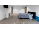 Contemporary bedroom with polished concrete floors, minimalist design, and recessed lighting at 3807 S Semoran Blvd, Orlando, FL 32822