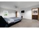 Bright bedroom with concrete floors, ensuite bath, modern ceiling fan, and minimalist design at 3807 S Semoran Blvd, Orlando, FL 32822