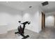 Bright exercise room featuring a stationary bike and concrete flooring at 3807 S Semoran Blvd, Orlando, FL 32822
