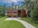 Stunning modern home with wood facade, garage, and manicured lawn, radiating curb appeal at 3807 S Semoran Blvd, Orlando, FL 32822