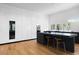 Modern kitchen with sleek white cabinets, a black island, stainless steel appliances, and hardwood floors at 3807 S Semoran Blvd, Orlando, FL 32822
