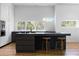Modern kitchen with sleek black countertops, light and dark cabinetry, and stainless steel appliances at 3807 S Semoran Blvd, Orlando, FL 32822