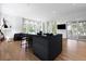 Spacious living area with hardwood floors, black kitchen island and glass sliding doors to balcony at 3807 S Semoran Blvd, Orlando, FL 32822