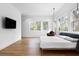 Bright main bedroom with hardwood flooring, a comfortable bed, and plenty of natural light at 3807 S Semoran Blvd, Orlando, FL 32822