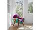 A bright sitting area with chair, hardwood floors and natural light coming through the window at 3807 S Semoran Blvd, Orlando, FL 32822