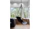 Cozy corner featuring a swing chair near large windows, flooding the space with natural light at 3807 S Semoran Blvd, Orlando, FL 32822