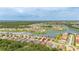 Aerial view of a lakeside neighborhood with a red pin marking a property in the residential area at 3837 Carrick Bend Dr, Kissimmee, FL 34746