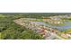 Aerial view featuring the home's location within a community, near lush trees and a peaceful lake at 3837 Carrick Bend Dr, Kissimmee, FL 34746