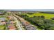A picturesque residential area situated near a marsh, green landscape, and serene blue lake in the distance at 3837 Carrick Bend Dr, Kissimmee, FL 34746