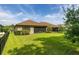 This backyard boasts a lush lawn, mature trees, and an inviting screened-in patio at 3837 Carrick Bend Dr, Kissimmee, FL 34746