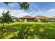 Wide backyard with lush lawn and mature trees, perfect for outdoor activities and relaxing afternoons at 3837 Carrick Bend Dr, Kissimmee, FL 34746