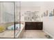 Elegant bathroom featuring a soaking tub with window view, spacious vanity with granite countertops, and marble tile floors at 3837 Carrick Bend Dr, Kissimmee, FL 34746