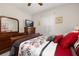 Comfortable bedroom featuring wood dresser with a television and a large window for natural light at 3837 Carrick Bend Dr, Kissimmee, FL 34746