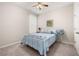 Comfortable bedroom with a striped quilt, a ceiling fan, and neutral-colored walls, creating a serene atmosphere at 3837 Carrick Bend Dr, Kissimmee, FL 34746