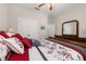 Bedroom with a bed, dresser with a large mirror, closet, and a view into the next room at 3837 Carrick Bend Dr, Kissimmee, FL 34746