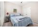 Comfortable bedroom with a striped quilt, a ceiling fan, and neutral-colored walls, creating a serene atmosphere at 3837 Carrick Bend Dr, Kissimmee, FL 34746