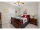 Cozy bedroom featuring a wooden sleigh bed with red and white bedding and matching nightstands at 3837 Carrick Bend Dr, Kissimmee, FL 34746