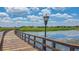 Community boardwalk with views of waterfront homes and lush green landscape at 3837 Carrick Bend Dr, Kissimmee, FL 34746