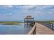 Relaxing community boardwalk extending over the water to covered gazebo viewing area at 3837 Carrick Bend Dr, Kissimmee, FL 34746