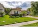 Charming home with a tile roof, well-manicured lawn, and a brick driveway at 3837 Carrick Bend Dr, Kissimmee, FL 34746