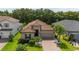 Charming single-story home features a tile roof, well-manicured lawn, and a two-car garage at 3837 Carrick Bend Dr, Kissimmee, FL 34746