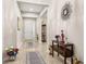 The foyer has marble floors, neutral wall paint, a decorative mirror, and beautiful decor throughout at 3837 Carrick Bend Dr, Kissimmee, FL 34746