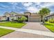 Charming home with a tile roof, well-manicured lawn, and a brick driveway at 3837 Carrick Bend Dr, Kissimmee, FL 34746