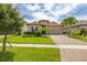 Charming home with a tile roof, well-manicured lawn, and a brick driveway at 3837 Carrick Bend Dr, Kissimmee, FL 34746