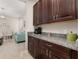 A kitchen area with dark wood cabinets, granite countertops and a coffee station at 3837 Carrick Bend Dr, Kissimmee, FL 34746