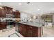 A wide view of the kitchen featuring a large island, granite countertops and stainless steel appliances at 3837 Carrick Bend Dr, Kissimmee, FL 34746