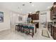 Spacious open kitchen with a large center island, granite countertops and dark wood cabinets at 3837 Carrick Bend Dr, Kissimmee, FL 34746
