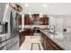 A bright kitchen showcasing granite countertops, stainless steel appliances, and ample cabinet space at 3837 Carrick Bend Dr, Kissimmee, FL 34746