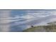 Person fishing on a peaceful lake with reeds and blue water at 3837 Carrick Bend Dr, Kissimmee, FL 34746