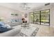A cozy living room featuring tile flooring, neutral paint, and sliding glass doors to the patio at 3837 Carrick Bend Dr, Kissimmee, FL 34746