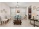 Bright living room showcases a light blue sofa, marble floors, natural light, and decor at 3837 Carrick Bend Dr, Kissimmee, FL 34746