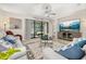 A bright living room with a sliding glass door to the patio and a large TV at 3837 Carrick Bend Dr, Kissimmee, FL 34746