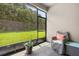 Relaxing screened patio with view of the landscaped backyard with lush green grass and mature trees at 3837 Carrick Bend Dr, Kissimmee, FL 34746
