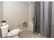 Bathroom featuring a toilet, tile floors, and a shower and tub combination with a curtain at 4008 San Sebastian Dr # 105, Kissimmee, FL 34741