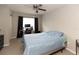 Bedroom with carpeted floors, ceiling fan, a desk, and a large window with black curtains at 4008 San Sebastian Dr # 105, Kissimmee, FL 34741